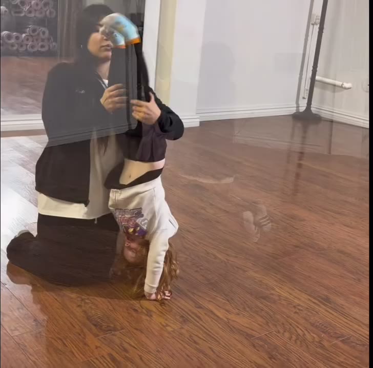 Teacher spotting a student’s handstand in an acro class at Sanchez Studio